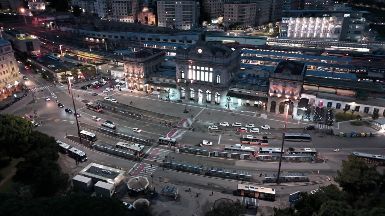 Night drone arc view of traffic on street in front of Brignole railway station