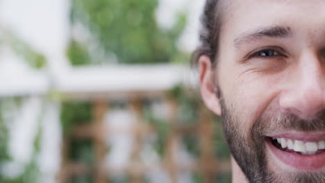 Portrait-of-happy-caucasian-man-smiling-in-garden,-slow-motion,-copy-space