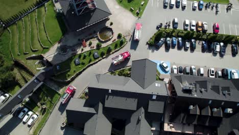 4k-Bird-Eye-Shot-of-Fire-Trucks-Driving-on-Curvy-Road-between-Buildings-and-Cars