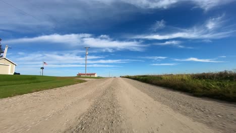 point of view footage while driving down a gravel road in rural iowa as turns are made the automobile shadow shifts