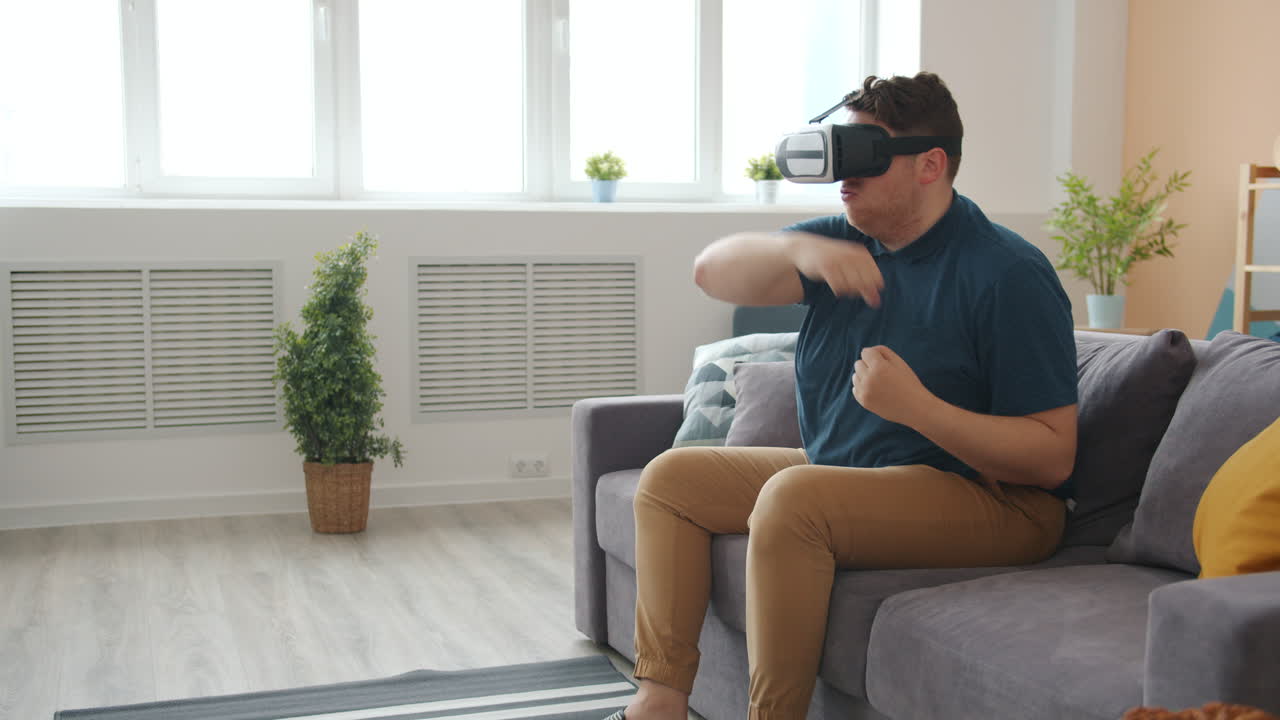 Man Playing VR Game on Couch