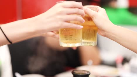 friends toasting with drinks in a restaurant