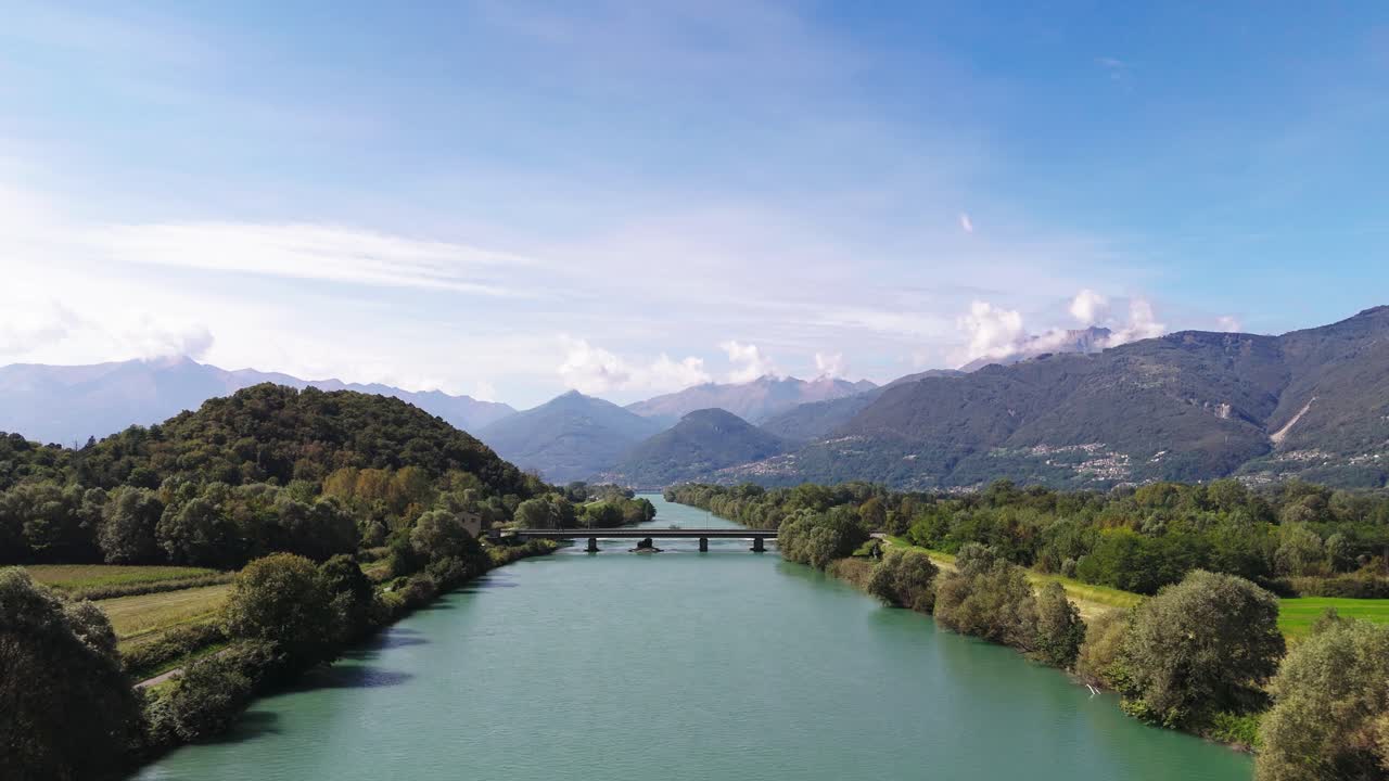 Fly low towards bridge over Adda river, Italy