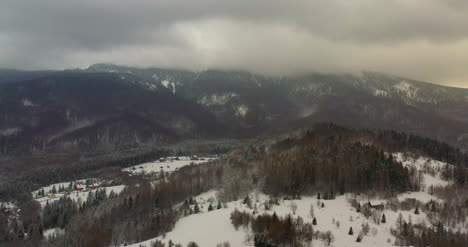 Aerial-View-Of-Forest-Covered-With-Snow-In-Mountains-6