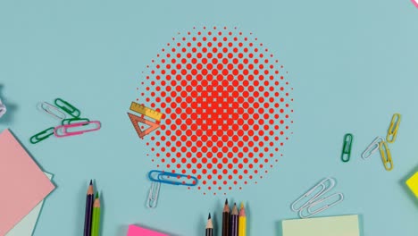 animación de libro rosa y gobernantes rebotando en puntos rojos sobre un escritorio azul con papelería