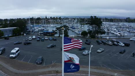 the american flag flies over the marina near a naval base