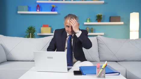 Home-office-worker-man-looks-at-camera-with-happy-and-smiling-face.