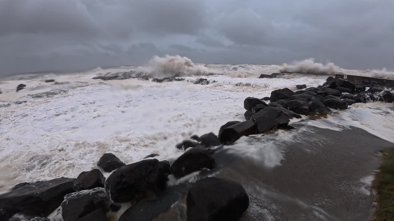 Swell Hitting The Seawall Rocks On Froggies Beach During Cyclone Alfred In Australia. - handheld shot