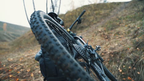 male cyclist carrying a mountain bike in the hill 1