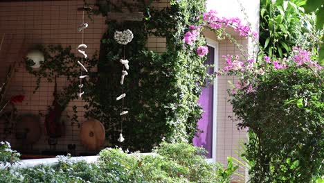 object falls past a flower-adorned balcony.