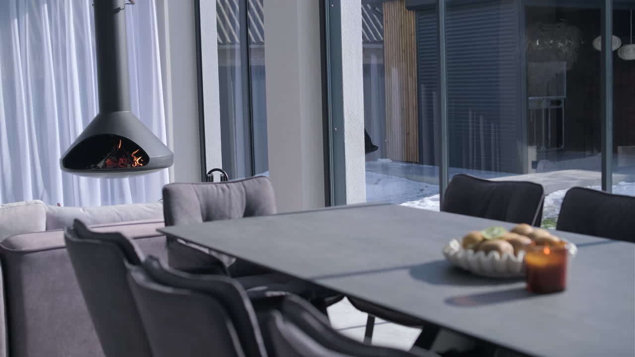 Modern Living Room with Hanging Fireplace and Dining Area