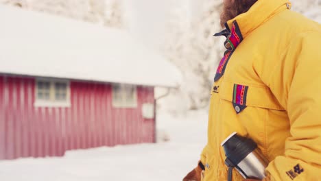 a man is throwing hot water in the air in wintertime