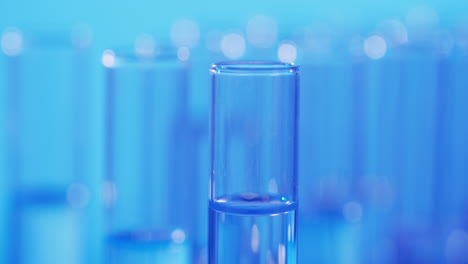 Video-of-laboratory-pipette-and-test-tubes-with-copy-space-on-blue-background