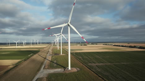 Drone-is-flying-upwards-alongside-a-wind-turbine