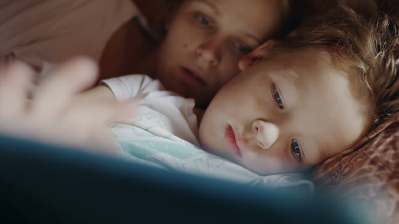 Mother and son with pad before bedtime
