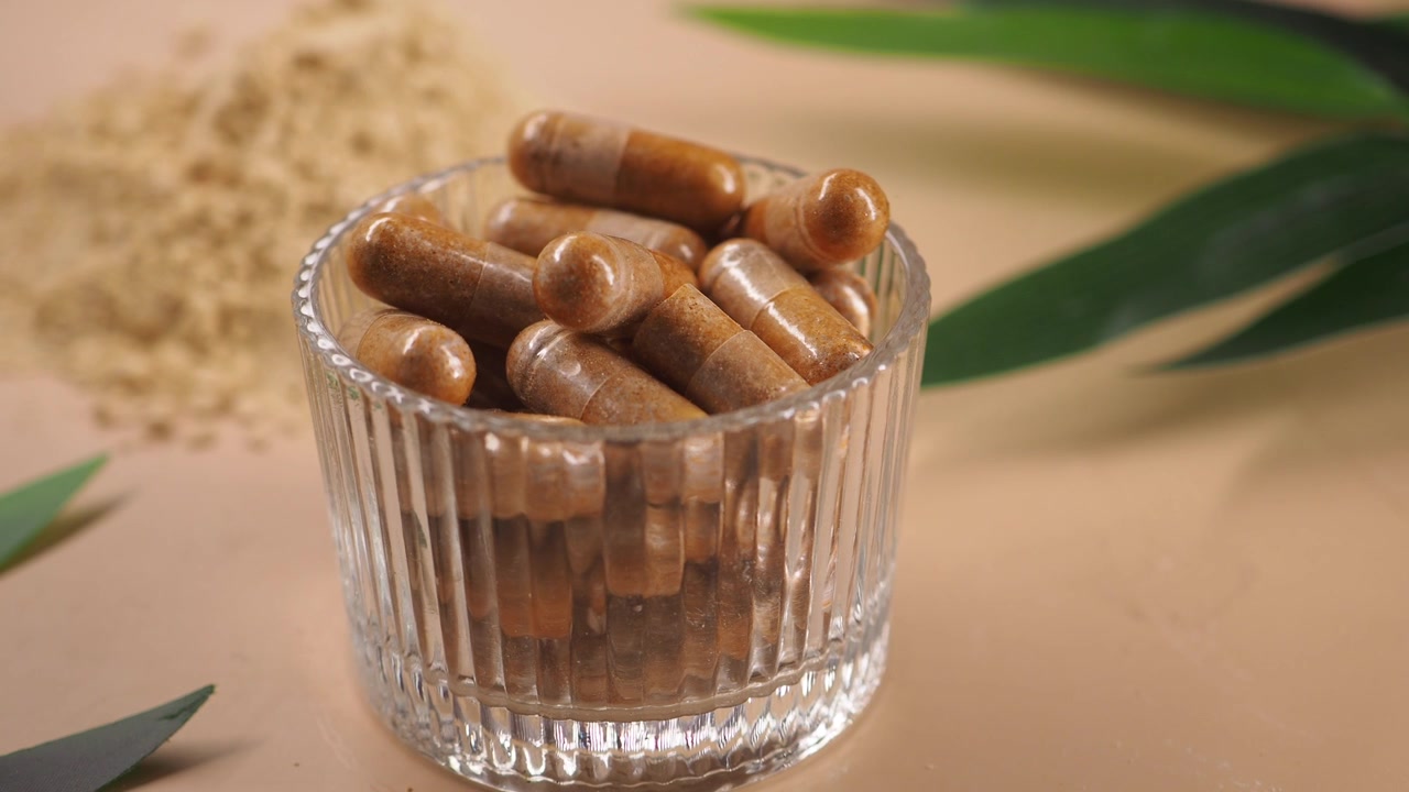 Barattolo di vetro contenente capsule erboristiche e polvere