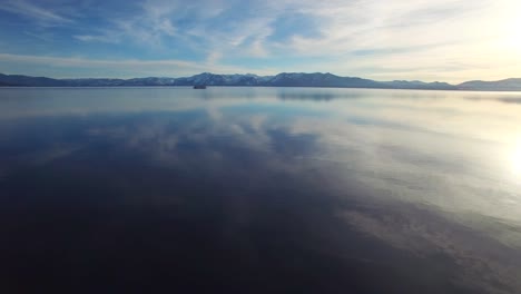 A-beautiful-aerial-shot-over-Lake-Tahoe-in-winter-with-a-paddlewheel-steamboat-in-distance-1