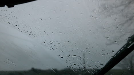 windscreen wiper wiping rain away from car window