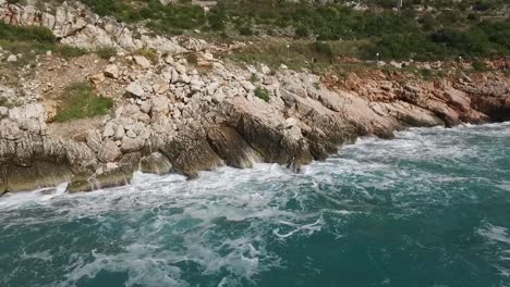 rocky coastline with waves and people