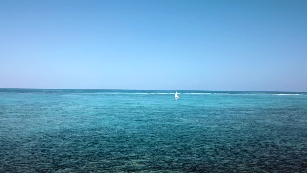 Buttery soft aerial flight fly forwards drone shot from the beach tu a sailing boat on reef.Paradise white sand dream beach Zanzibar, Africa 2019. Cinematic wild nature 1080, 60p by Philipp Marnitz