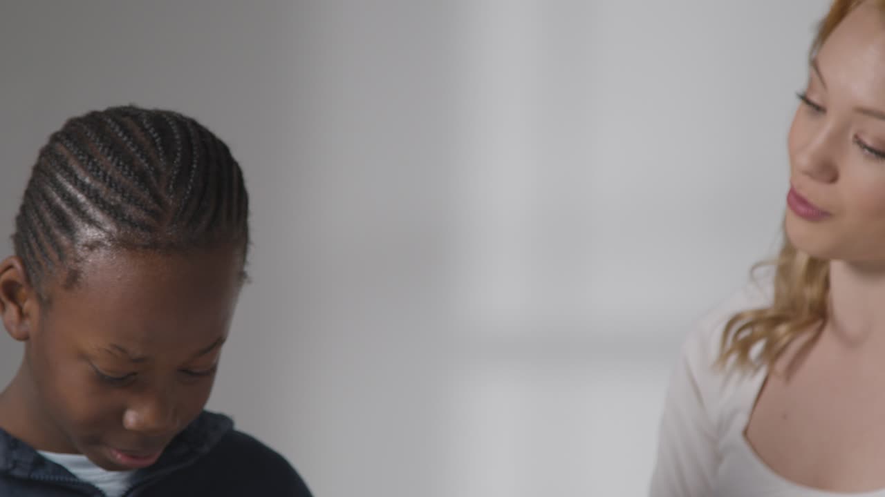 Boy On ASD Spectrum Being Helped Or Assessed By Female Teacher Or Educational Psychologist 1