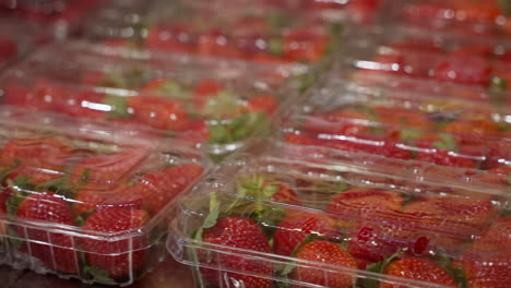 strawberries in plastic trays at a grocery store