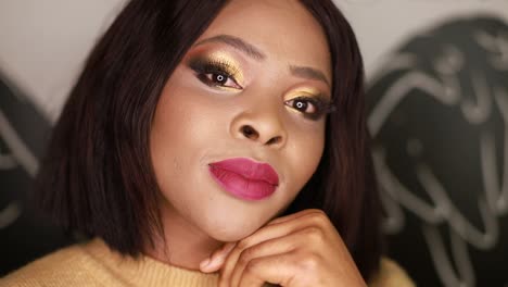 woman with golden eyeshadow and pink lipstick