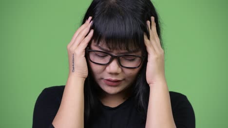 beautiful asian businesswoman having headache