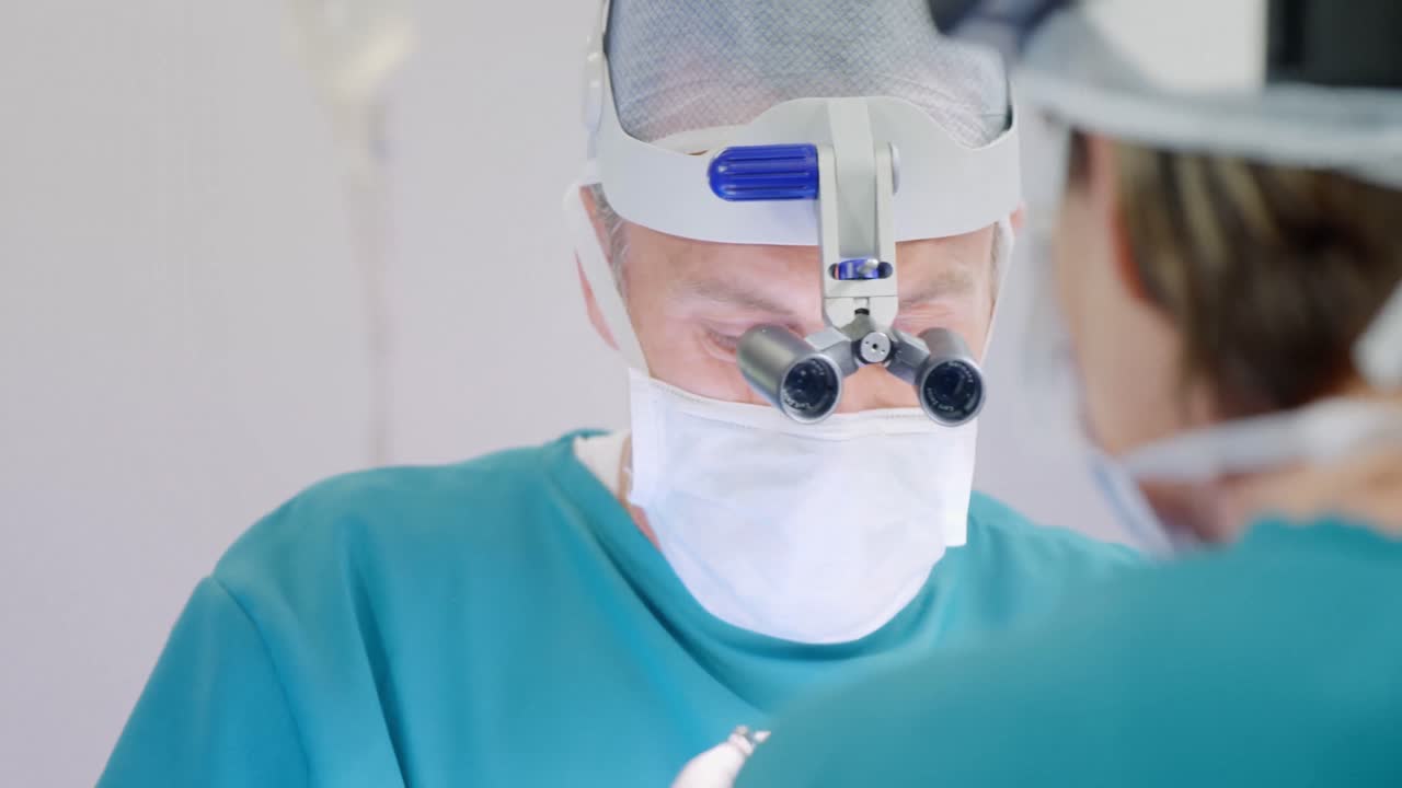 Surgery team operating a patient in an operating room