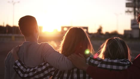 group of friends walking embracing and having fun together in city