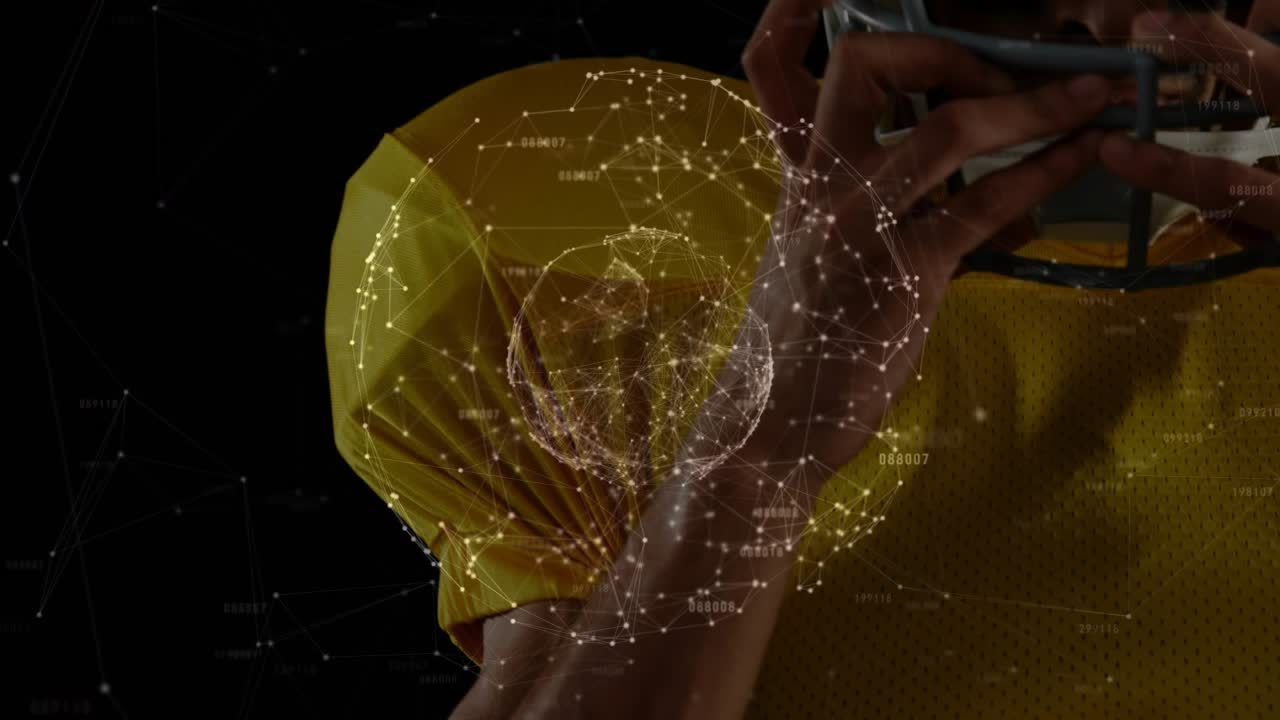 Football player responding to network sphere and adjusting helmet to secure fit before play