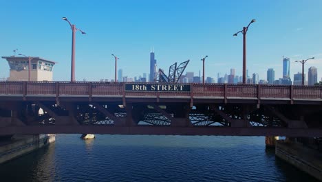 drone flying toward 18th street bridge sign over chicago river