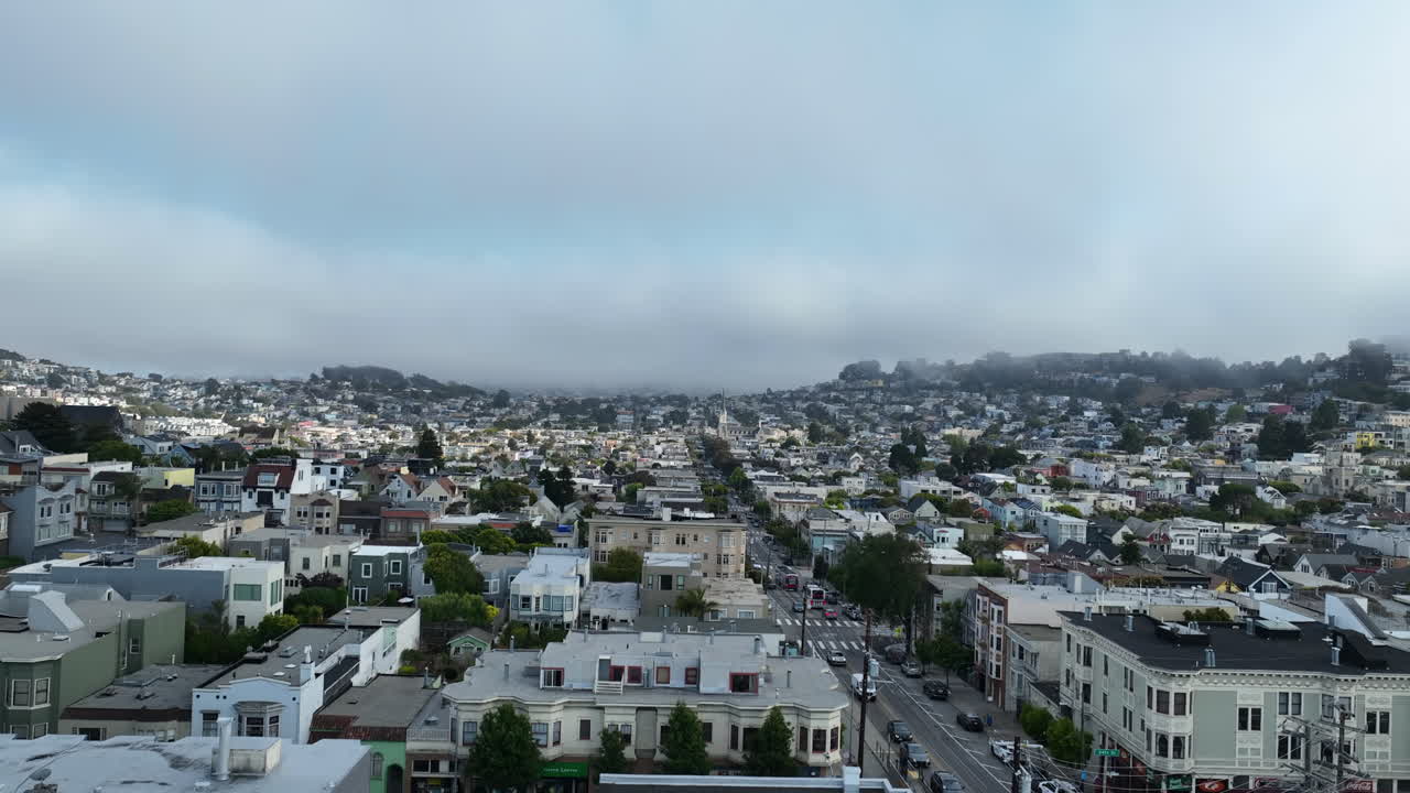 Drone rising low over houses in the suburbs of San Francisco, misty morning in USA