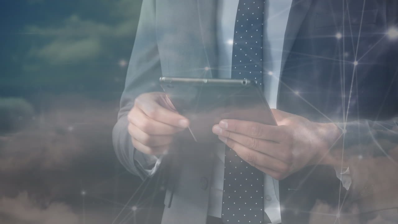Animation of networks of connections and sky over caucasian businessman using tablet