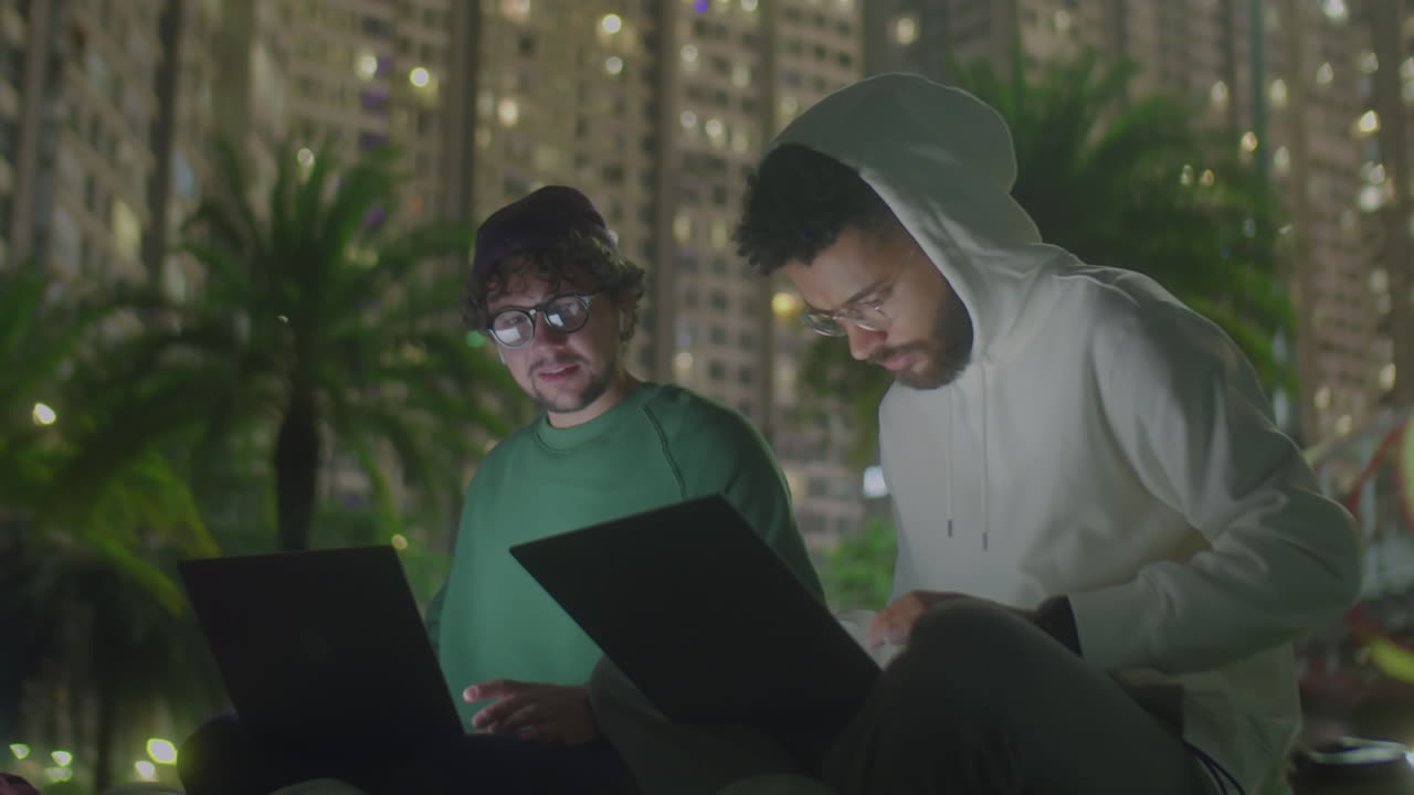 Young Freelancers Working on Laptops in Park during Night
