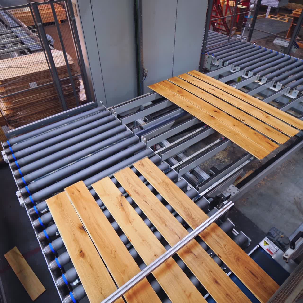 Wooden factory indoors. Production line with laminated panels. Workers inside the parquet plant. Laminate flooring concept.