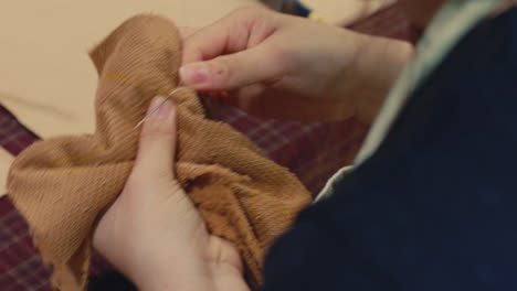 close-up of someone sewing