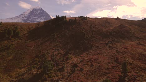 aerial-reveal-shot-of-Eiger,-Moench-and-Jungfrau-in-beautiful-fall-colors