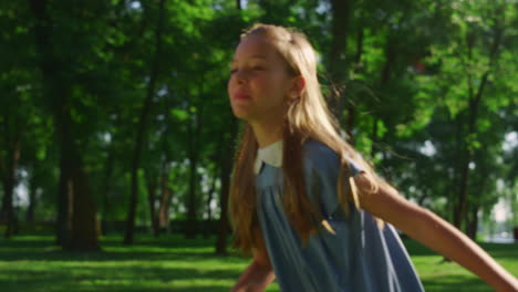 two focused siblings running in golden sunlight park closeup. kids going away.