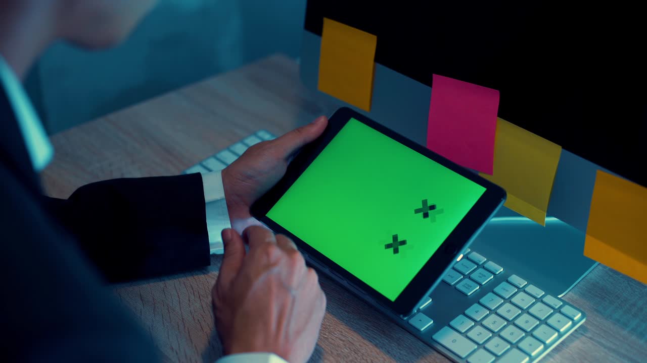 Business man looking tablet green screen