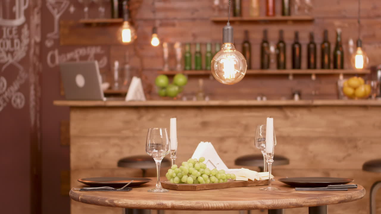 Romantic Dinner Setting with Grapes, Cheese, and Wine Glasses