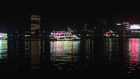 cruise lit with colorful lights sailing across han river in da nang city, vietnam