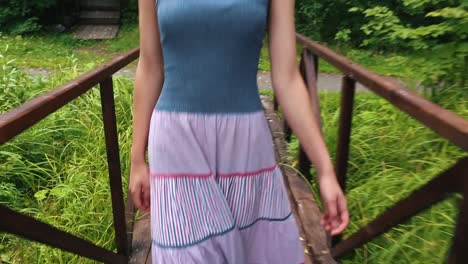 woman walking on a wooden bridge in nature