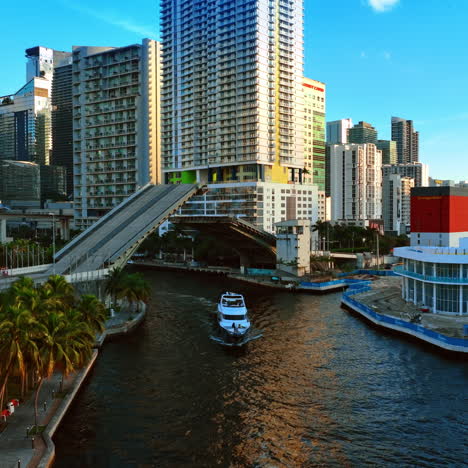 yacht sailing under the drawbridge and another motor boat approaches the bridge. view of beautiful miami, usa.