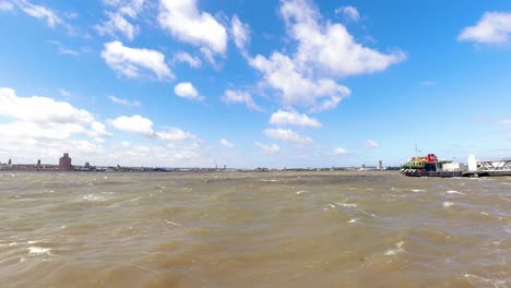 Time-lapse-clouds-casting-shadows-over-River-Mersey-iconic-Snowdrop-sightseeing-ferry-boat-Liverpool-waterfront-pier