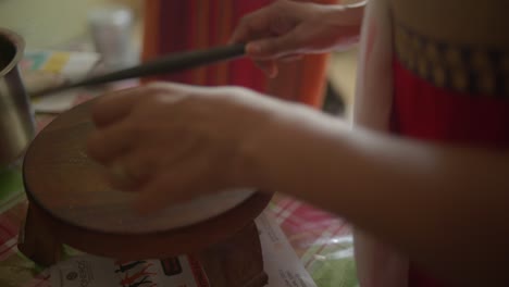 Woman-Hand-Rolling-Dough-into-Roti,-Rotli,-Chapati,-safati,-shabaati,-phulka,-chapo,-roshi,-India,-rolling-pin-into-balls-flat-bread-cultural-food-ethnic-bread