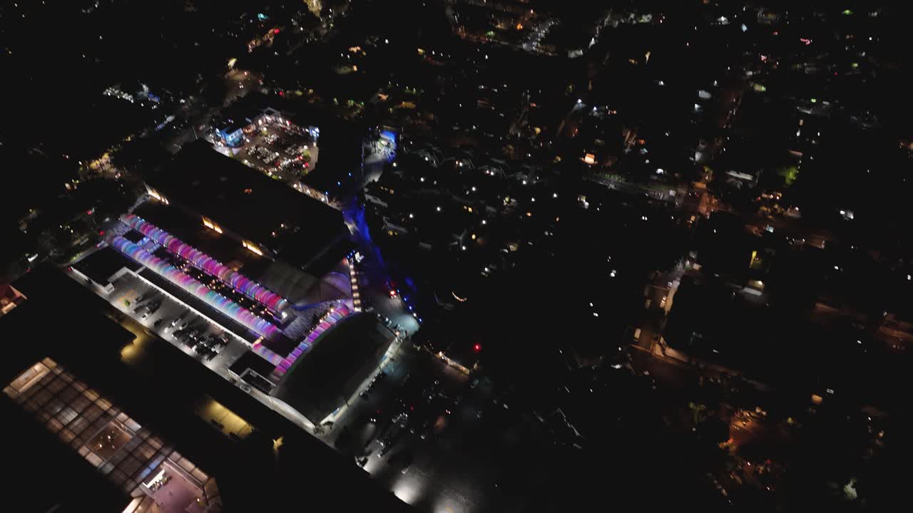 Nighttime tilt-down drone shot over a southern Mexico City neighborhood