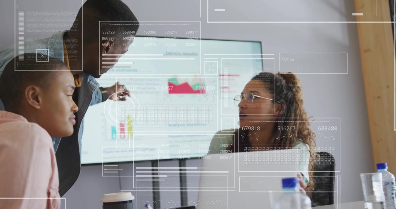 Biz team leaning around laptop, lead tapping tablet, pointing charts while reviewing, HUD onscreen