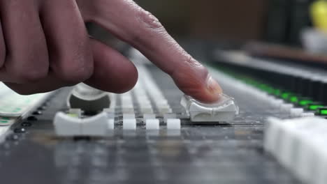 sound engineer adjusting mixing console