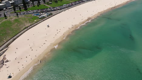 Aerial-View-Over-Bondi-Beach-With-Turquoise-Seascape-In-Sydney,-New-South-Wales,-Australia---drone-shot